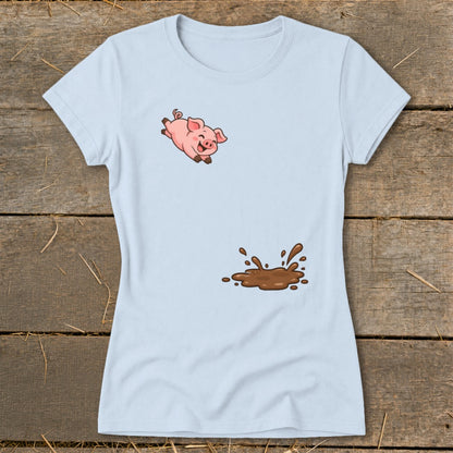 Light blue t-shirt with a cartoon pig jumping over a mud puddle graphic.