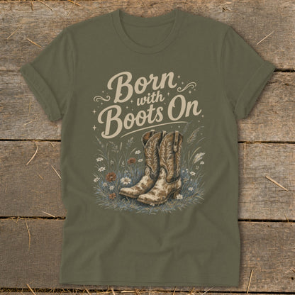 Olive green t-shirt with "Born with Boots On" text and cowboy boots graphic.