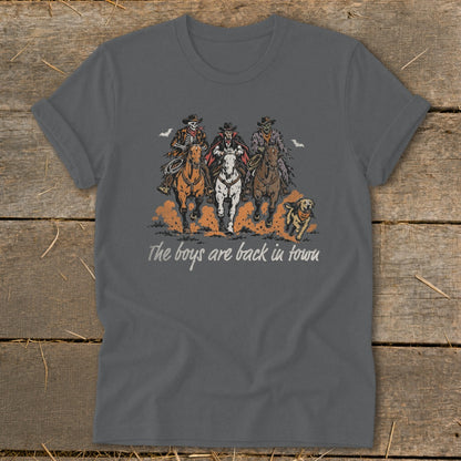 Dark grey t-shirt with three skeleton cowboys and a dog riding horses, text reads "The boys are back in town".