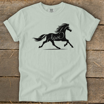 Black horse silhouette with "love" integrated into its body, on a light green t-shirt.