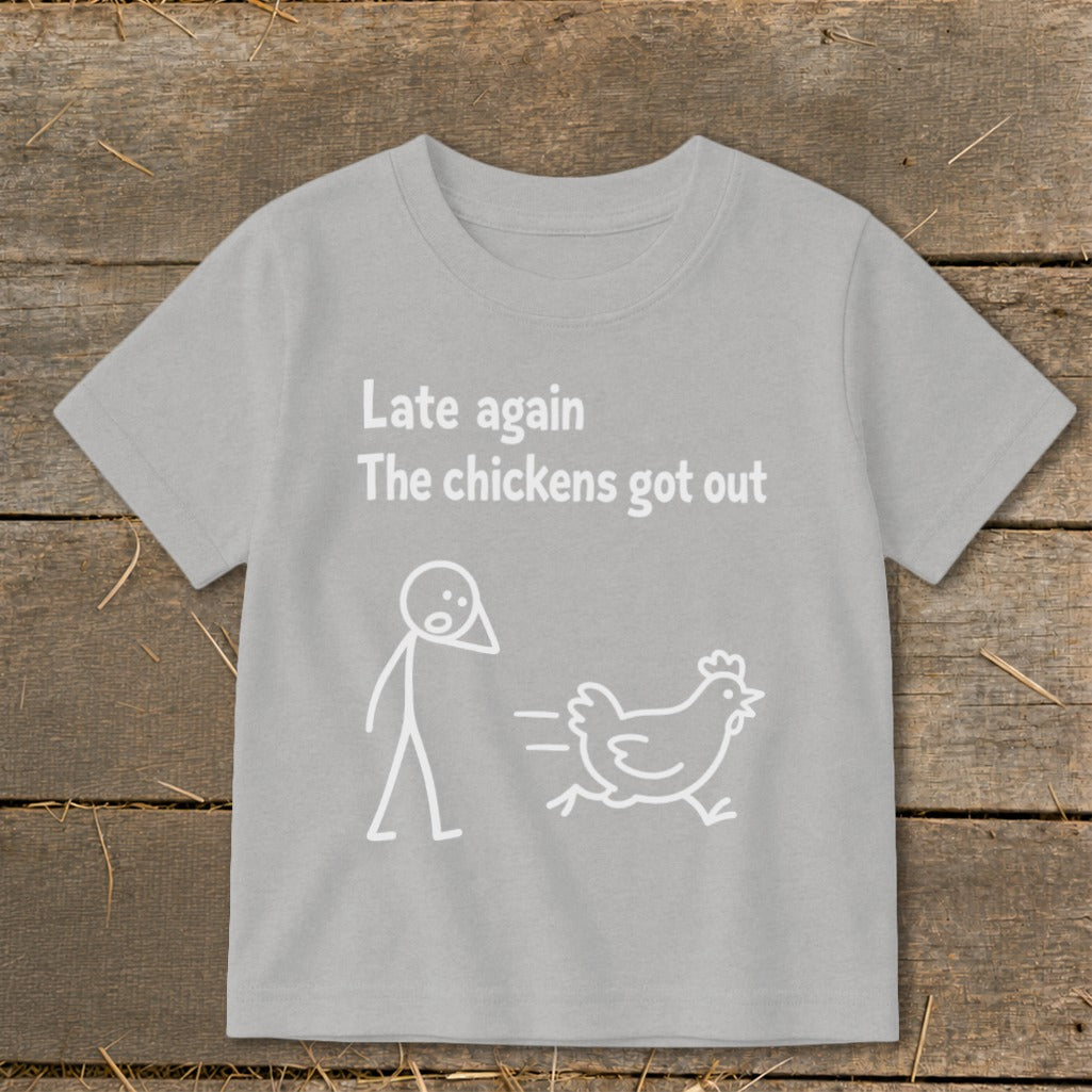 Grey t-shirt with white text "Late again The chickens got out" and stick figure chasing chicken.