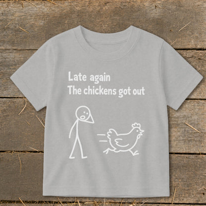 Grey t-shirt with white text "Late again The chickens got out" and stick figure chasing chicken.