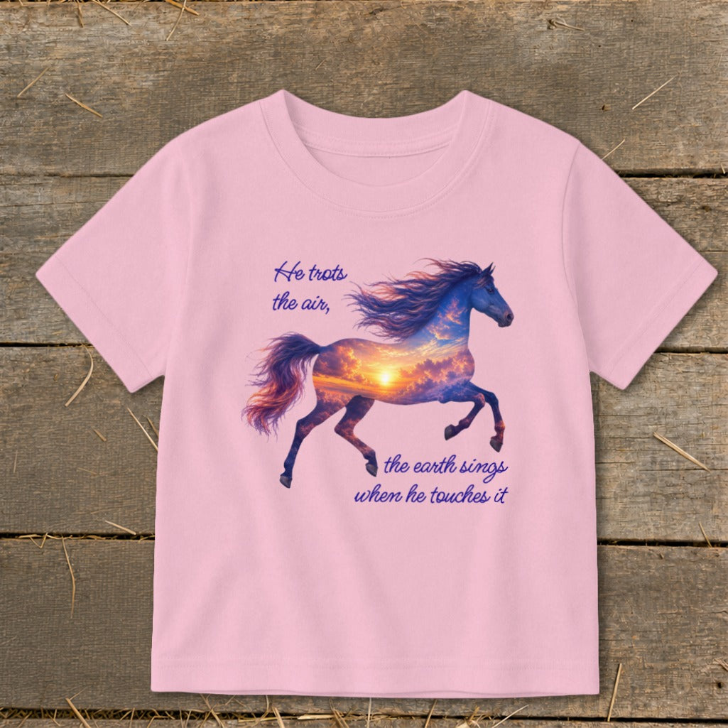 A pink short-sleeved t-shirt featuring a graphic of a running horse filled with a sunset sky and text that reads "He trots the air, the earth sings when he touches it".
