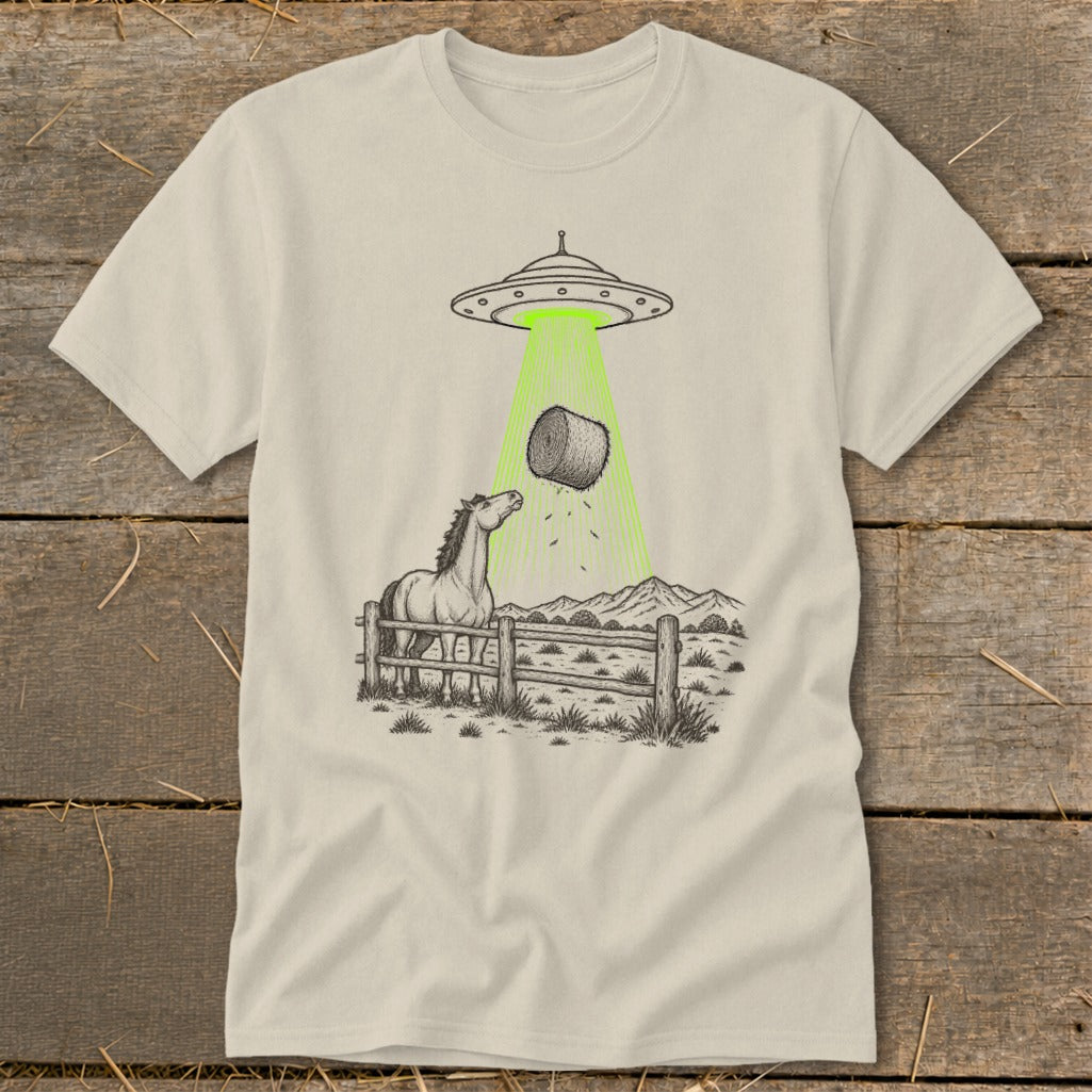 UFO beams a hay bale down on a horse in a fenced pasture.