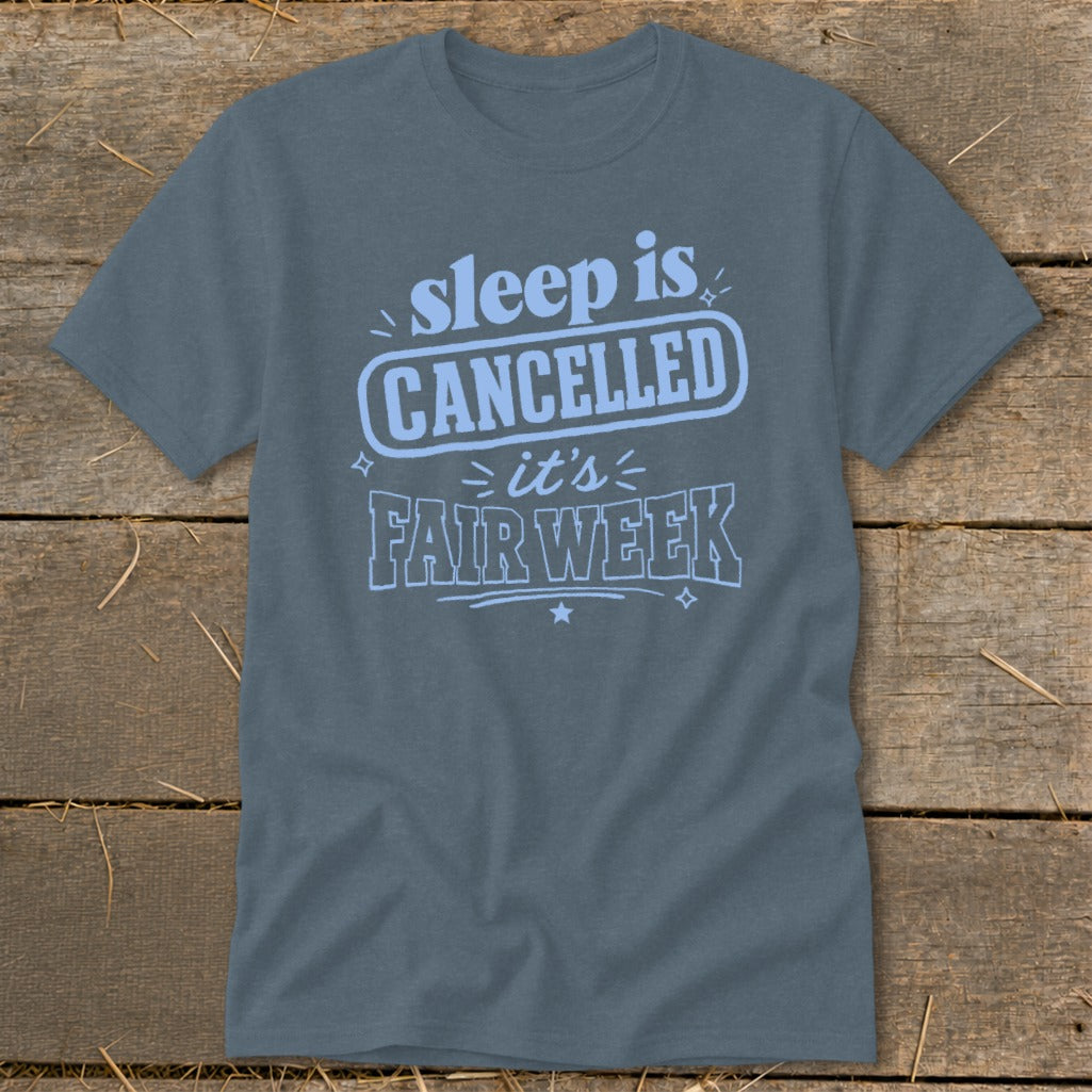 Blue t-shirt with light blue text "sleep is CANCELLED it's FAIR WEEK"