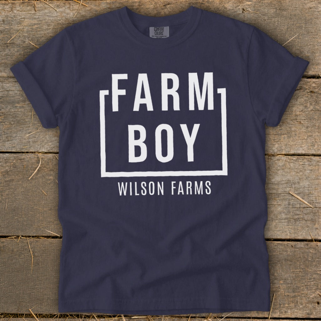 Navy t-shirt with white "FARM BOY WILSON FARMS" text inside a box.