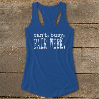 Blue racerback tank top with white text "can't. busy. FAIR WEEK."