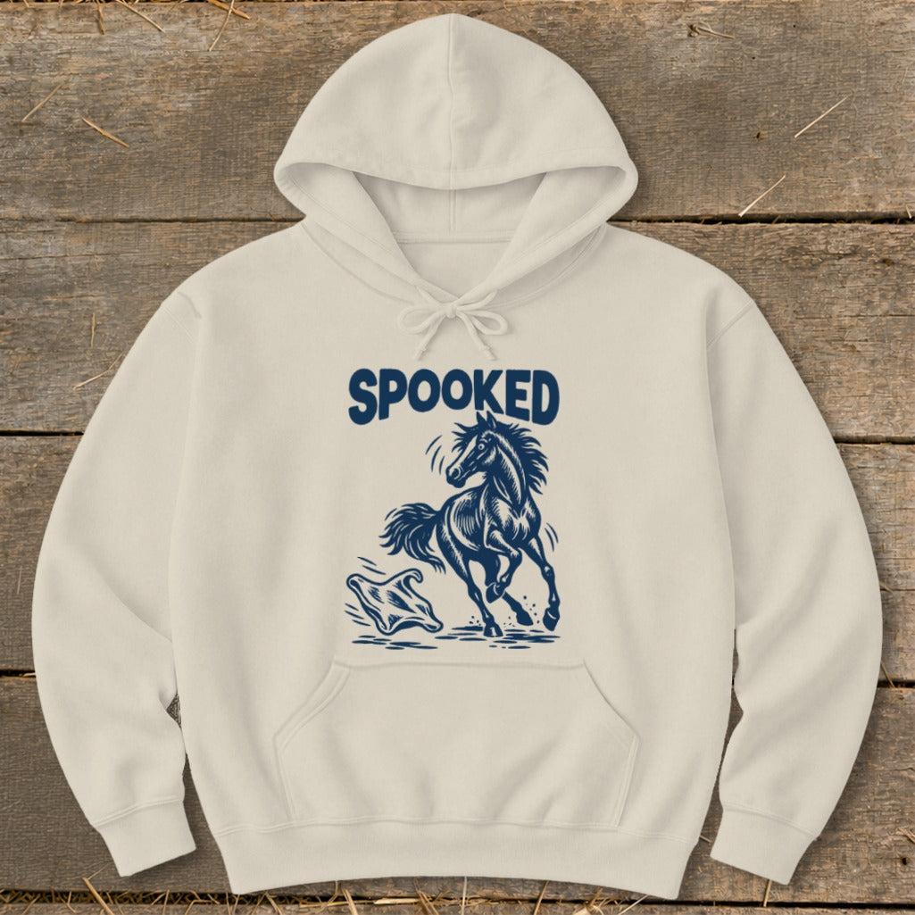 Cream hoodie with navy "SPOOKED" text and a startled horse graphic.