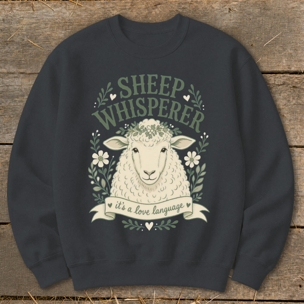 Sheep Whisperer text and sheep graphic with wreath on dark gray sweatshirt.