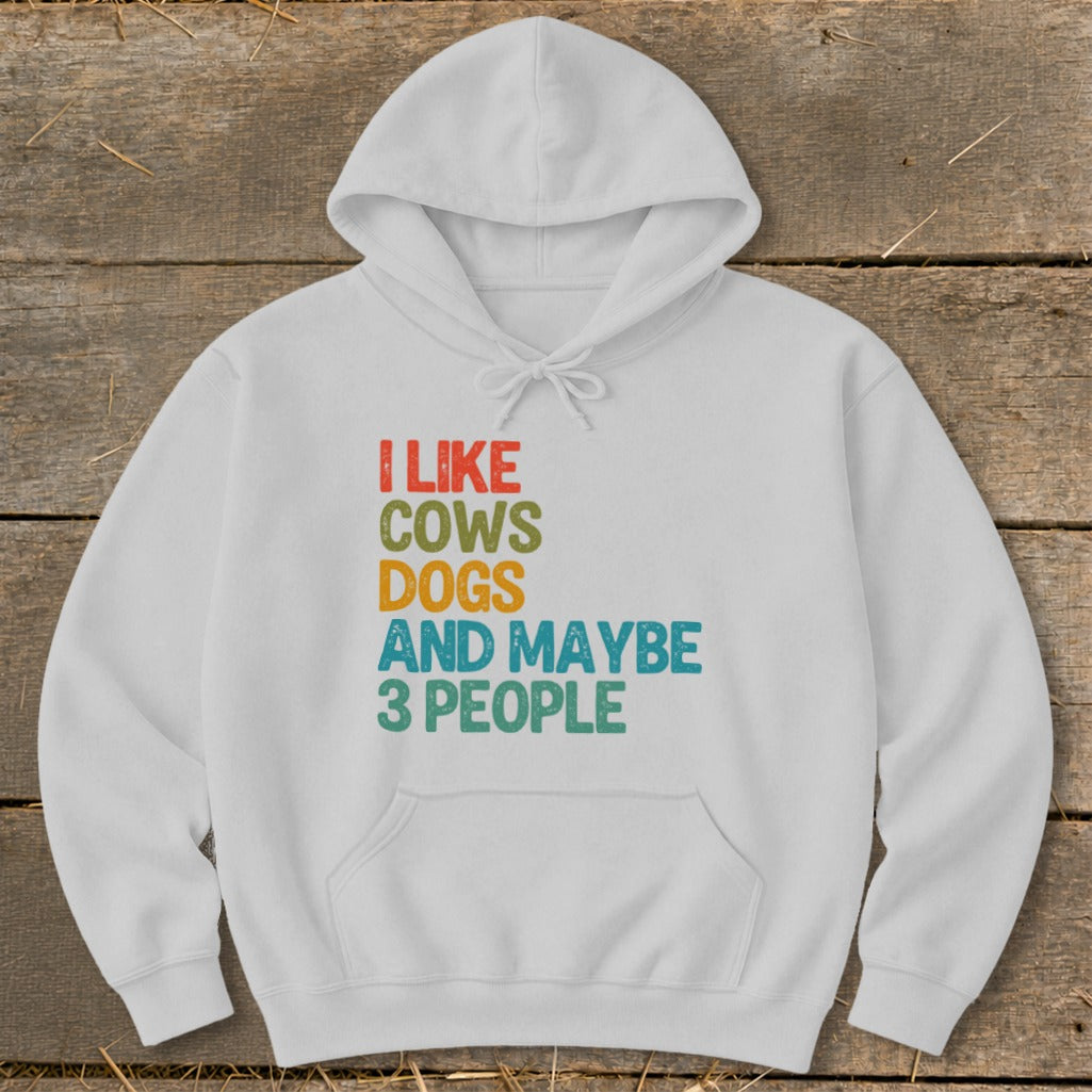 White hoodie with text "I LIKE COWS DOGS AND MAYBE 3 PEOPLE".