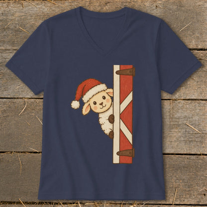 Sheep wearing Santa hat peeking around barn door on navy v-neck t-shirt.