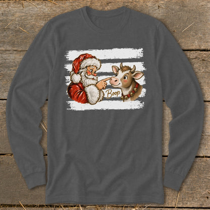 Santa boops a cow with the word "Boop" written on the shirt.