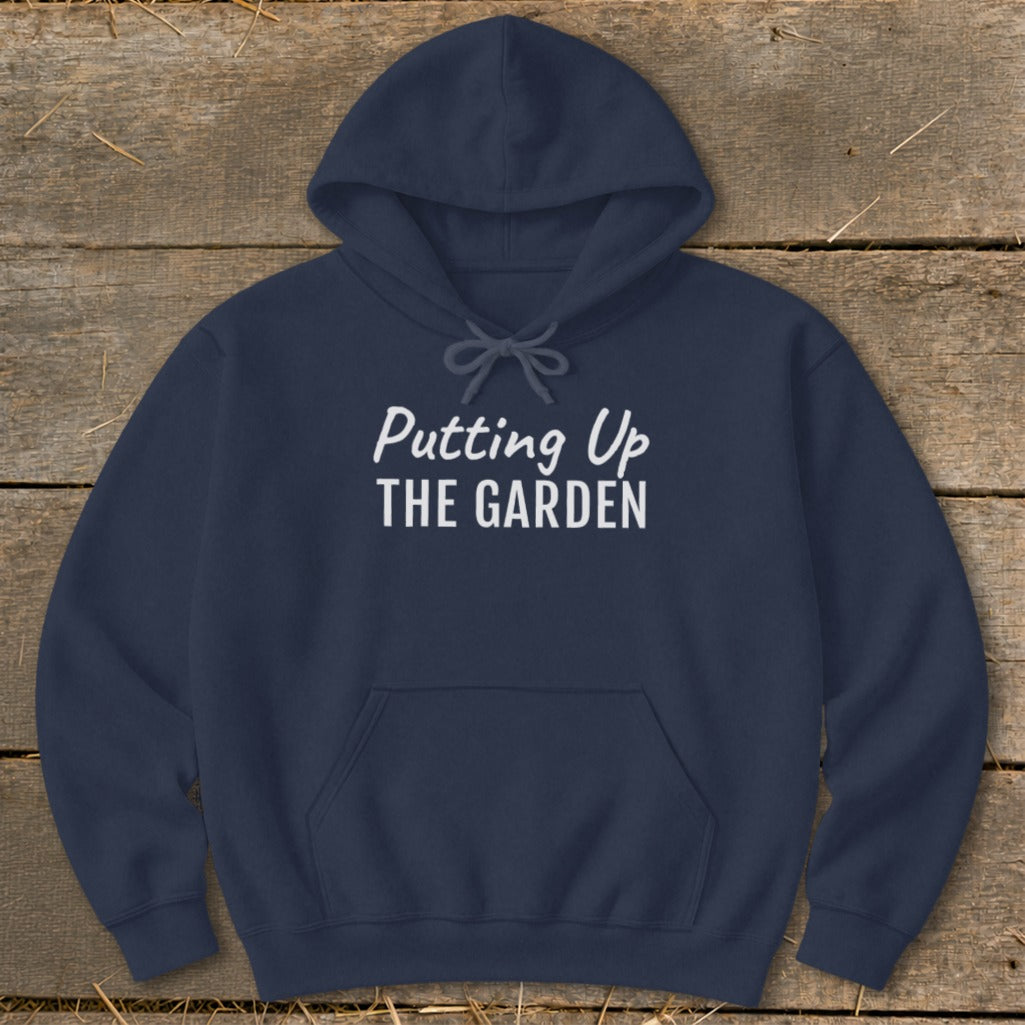 Navy hoodie with white text that reads "Putting Up THE GARDEN"