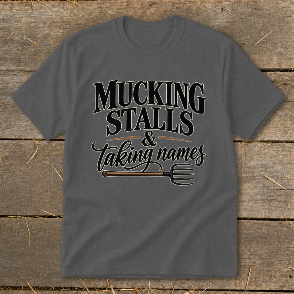 Grey t-shirt with "Mucking Stalls & Taking Names" text and a pitchfork graphic.