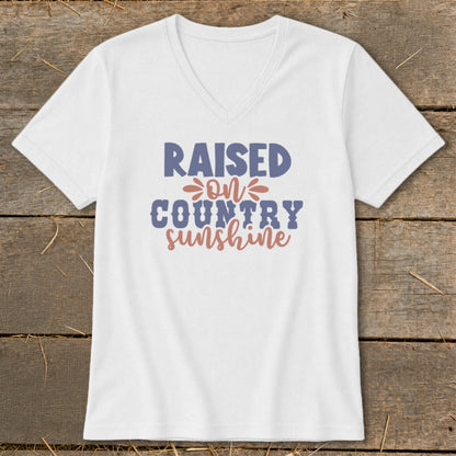 White v-neck t-shirt with "Raised on Country Sunshine" text design.