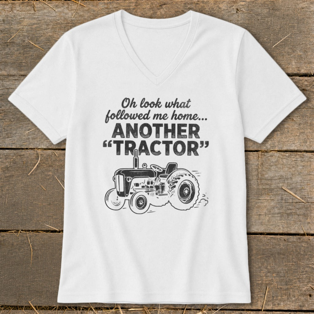 White v-neck t-shirt with "Oh look what followed me home... ANOTHER 'TRACTOR'" text and a tractor graphic.