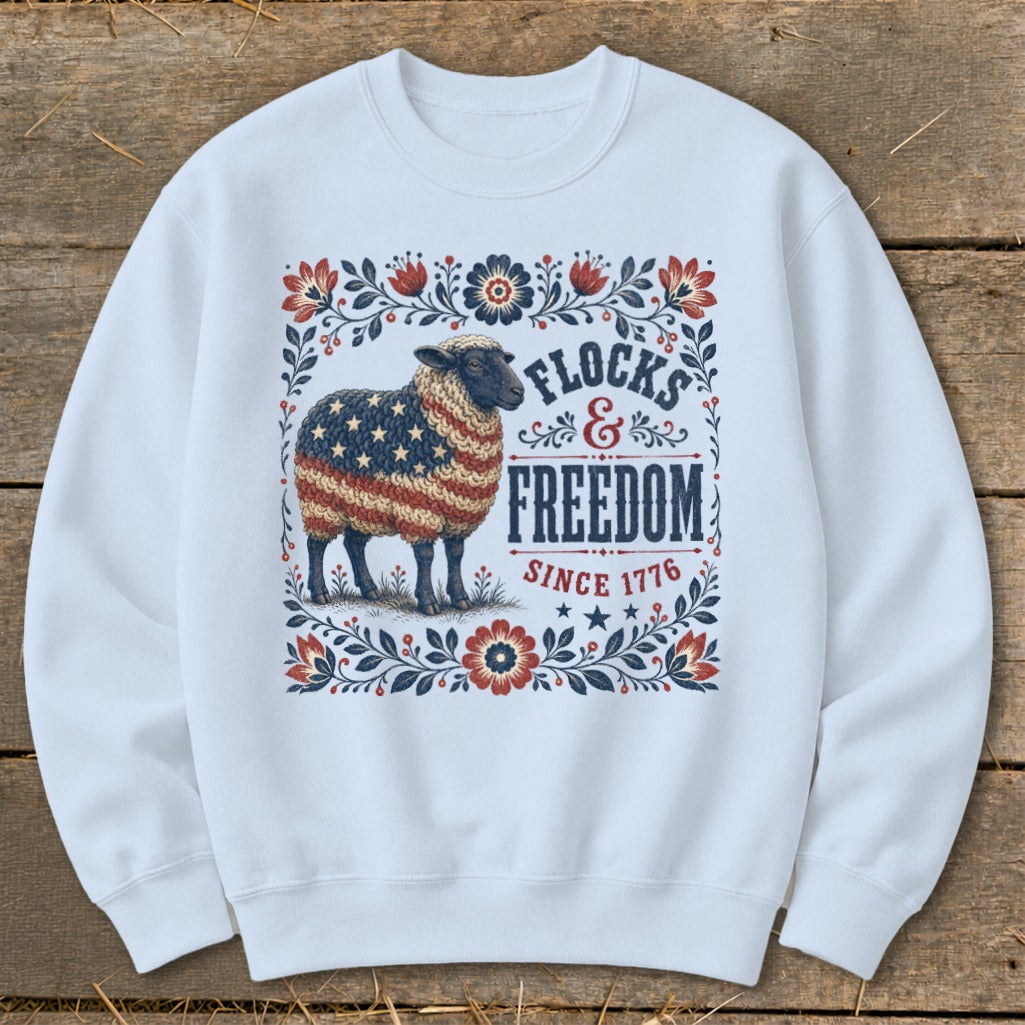 Sheep with American flag wool, text "Flocks & Freedom Since 1776" and floral border.