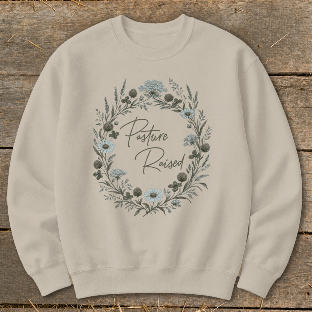 Tan crewneck sweatshirt with floral wreath and "Pasture Raised" text.