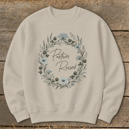 Tan crewneck sweatshirt with floral wreath and "Pasture Raised" text.