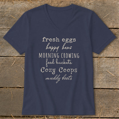 Navy v-neck t-shirt with text: fresh eggs, happy hens, morning crowing, feed buckets, cozy coops, muddy boots.