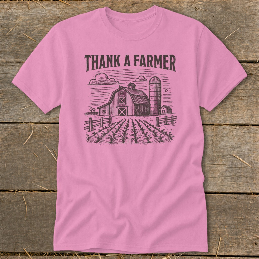 Pink t-shirt with "THANK A FARMER" text and farm sketch.