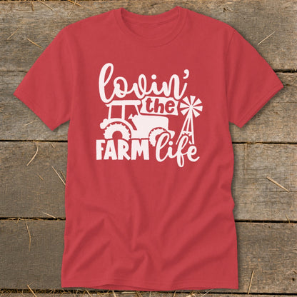 Red t-shirt with white "lovin' the FARM life" text, tractor, and windmill graphic.