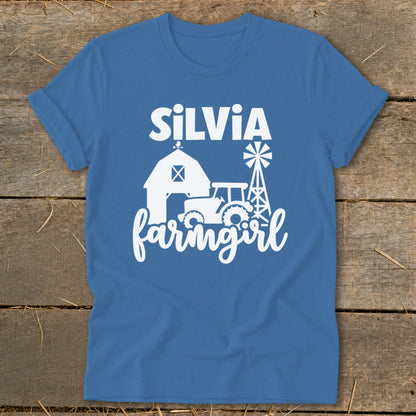 Blue t-shirt with "Silvia farmgirl" text, barn, tractor, and windmill graphics.