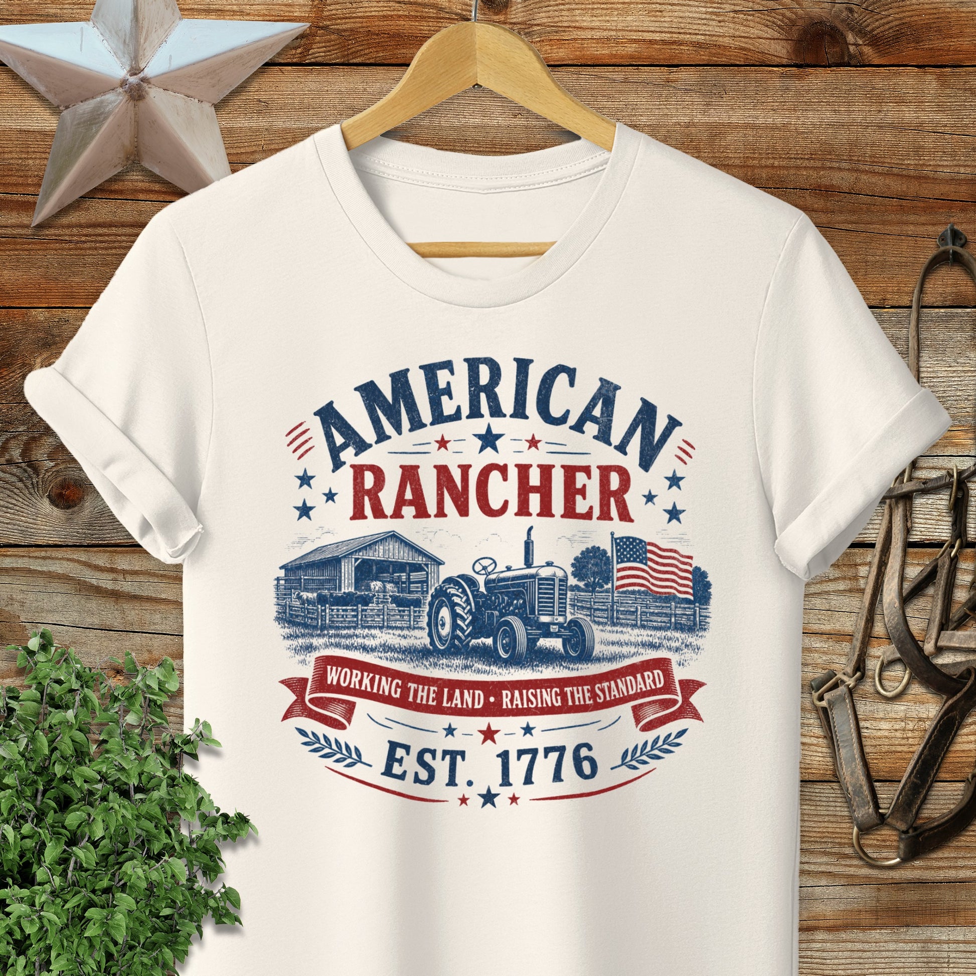 Cream t-shirt with "American Rancher Est. 1776" text and tractor graphic.