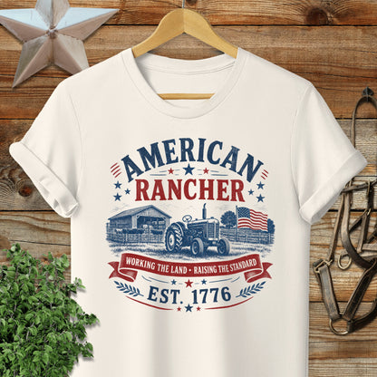 Cream t-shirt with "American Rancher Est. 1776" text and tractor graphic.