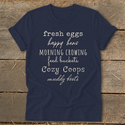 Navy t-shirt with text "fresh eggs happy hens MORNING CROWING feed buckets Cozy Coops muddy boots".