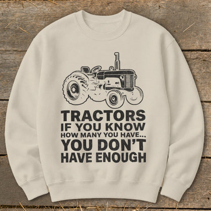 Cream sweatshirt with a vintage tractor graphic and text "Tractors if you know how many you have... You don't have enough."