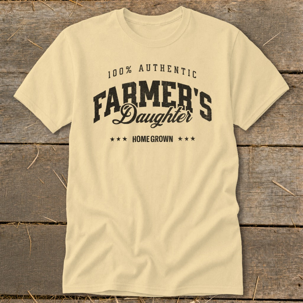 Cream t-shirt with "100% AUTHENTIC FARMER'S Daughter HOME GROWN" text.