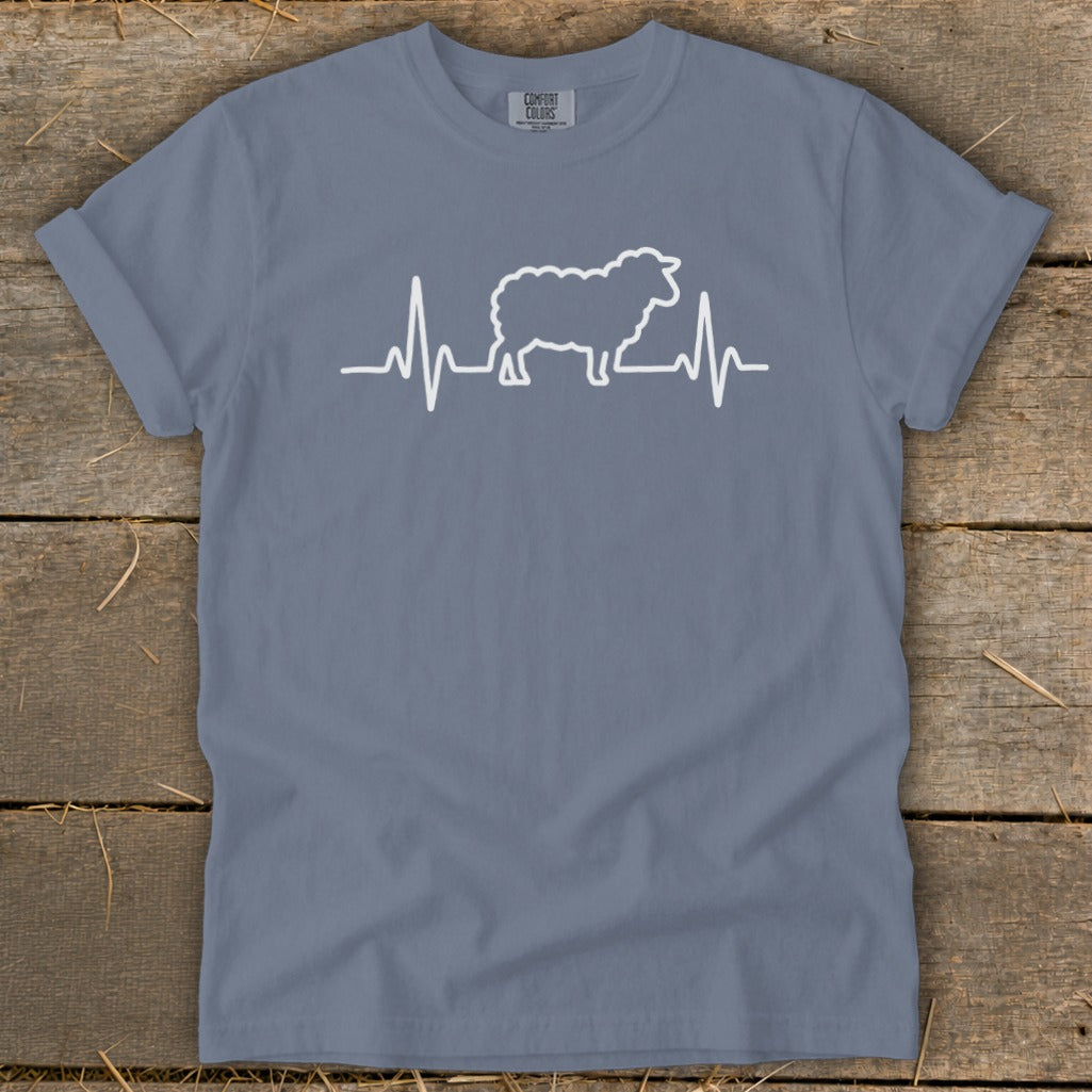 Blue crewneck t-shirt with a white graphic of a sheep integrated into an electrocardiogram heartbeat line.