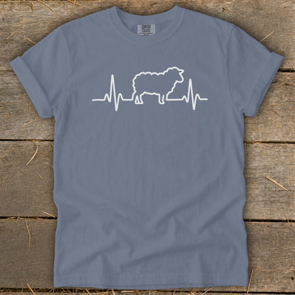 Blue crewneck t-shirt with a white graphic of a sheep integrated into an electrocardiogram heartbeat line.