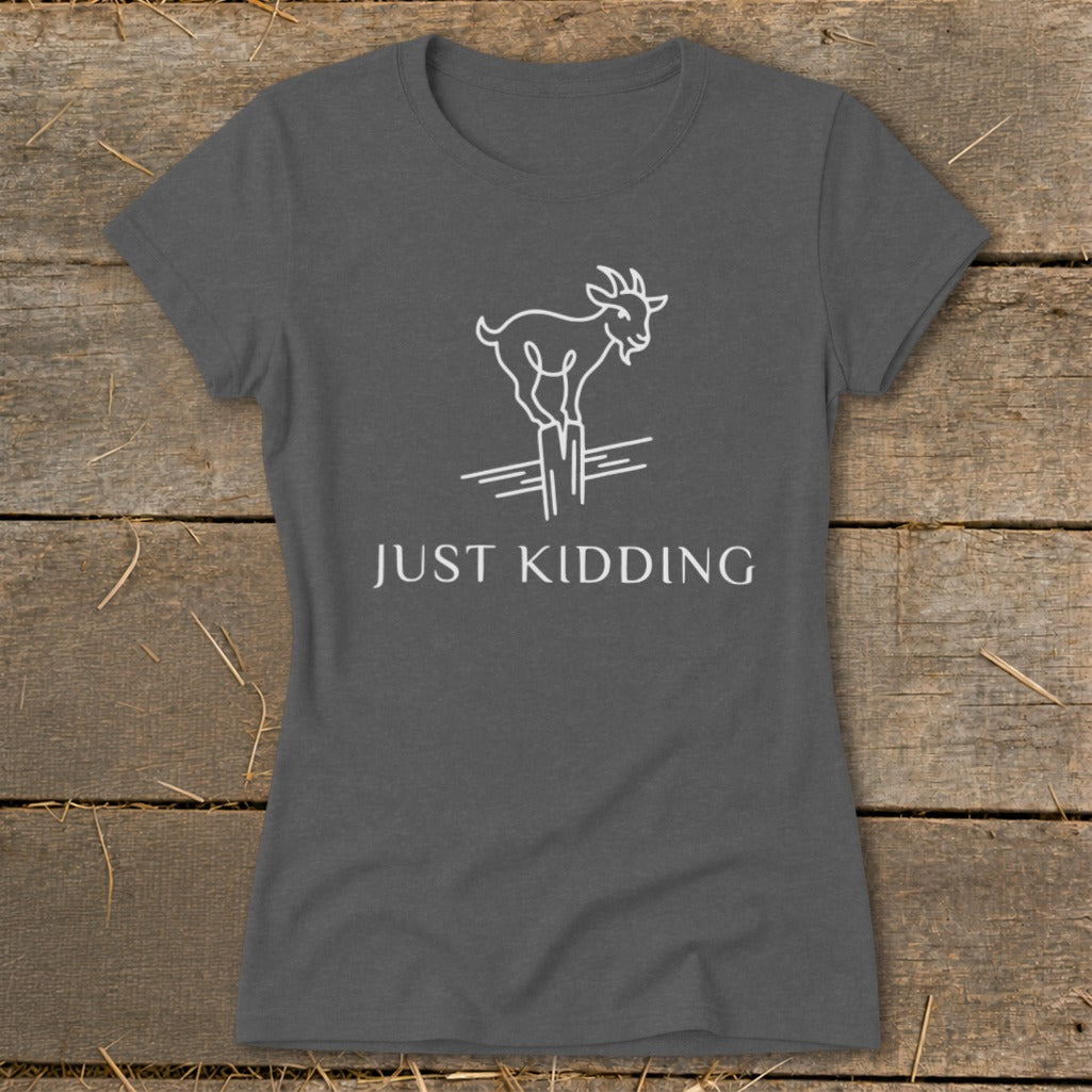 Grey t-shirt with white line drawing of a goat on fence posts, text reads "JUST KIDDING".