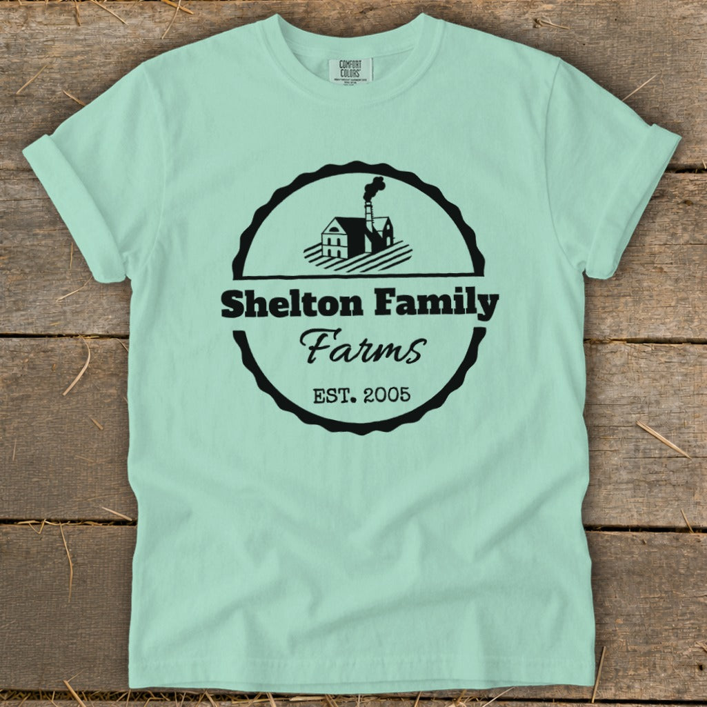 Mint t-shirt with Shelton Family Farms logo, featuring a house and fields.