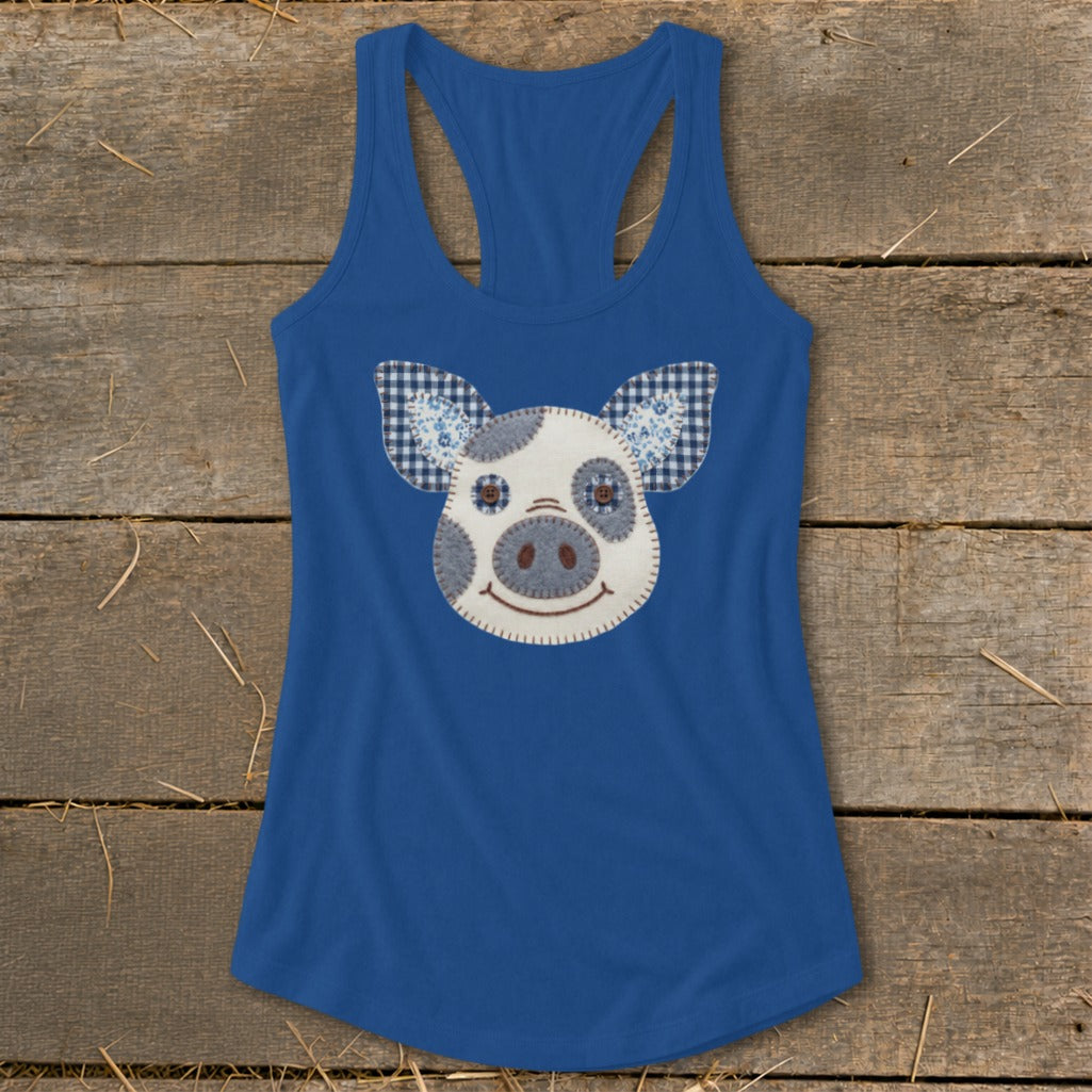 Blue tank top with a patchwork pig face applique on the front.