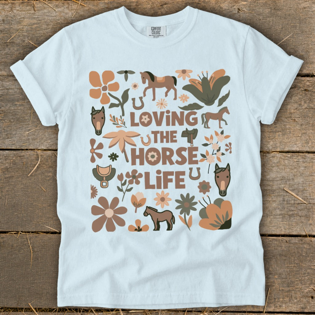 White t-shirt with "Loving The Horse Life" text and horse, flower, and horseshoe graphics.