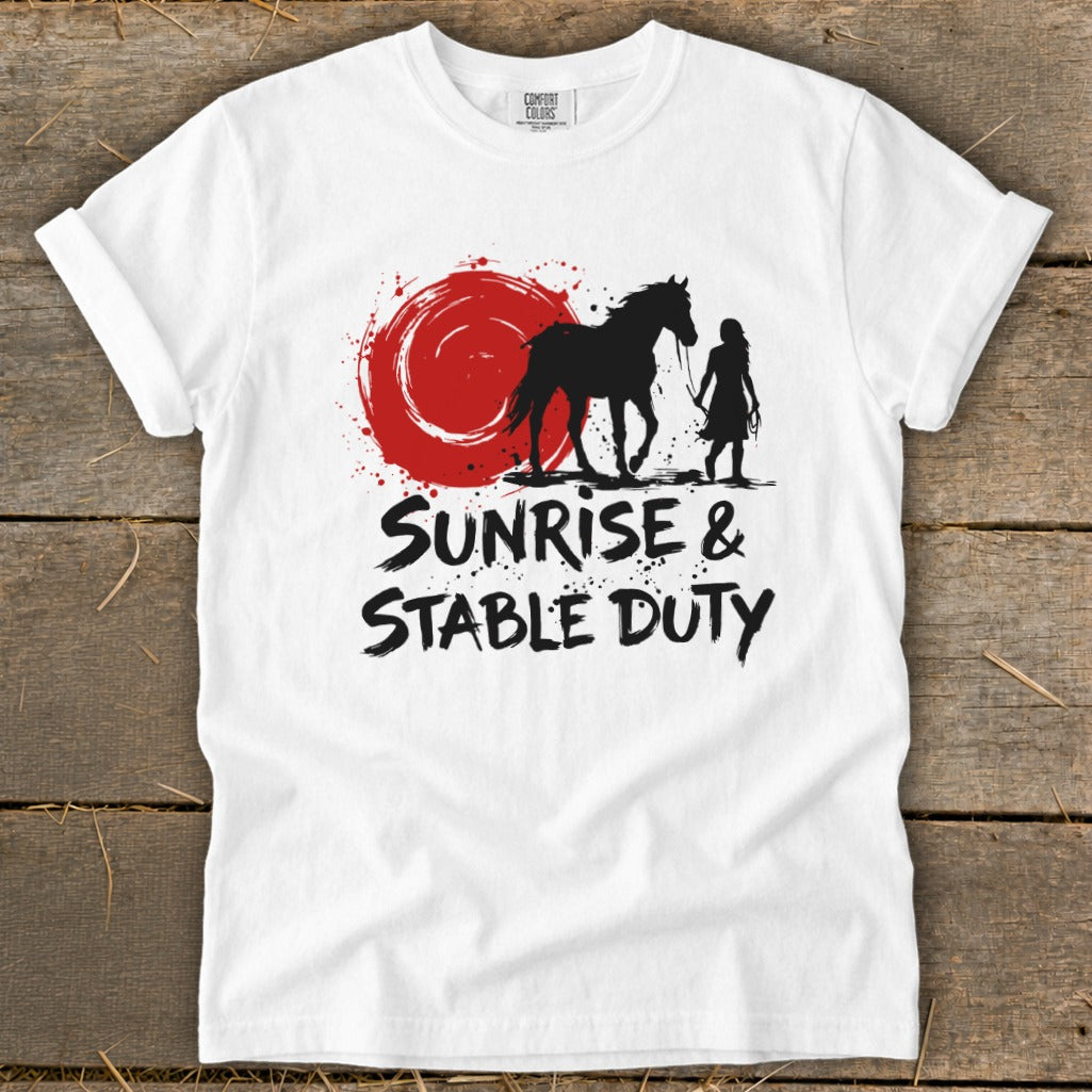 White t-shirt with black graphic of horse, rider, and red sun, reading "Sunrise & Stable Duty".
