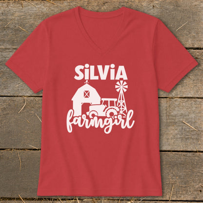 Red v-neck t-shirt with white "Silvia farmgirl" text and farm graphics.