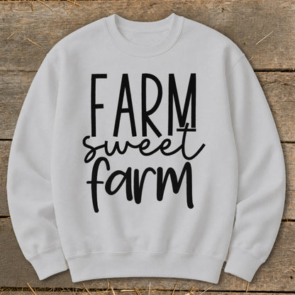 White sweatshirt with "FARM sweet farm" text in black lettering.