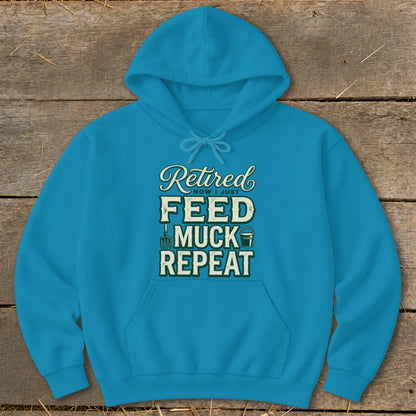 Blue hoodie with "Retired Now I Just Feed Muck Repeat" text and farm icons.