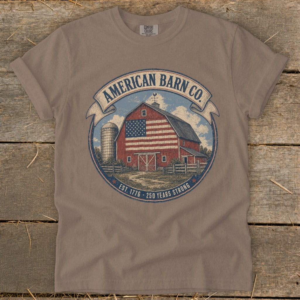 T-shirt graphic with a barn, silo, flag, and text "American Barn Co. Est. 1776 - 250 Years Strong".