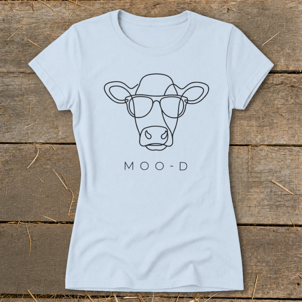 Light blue t-shirt with black line drawing of a cow wearing sunglasses and text "MOO-D".