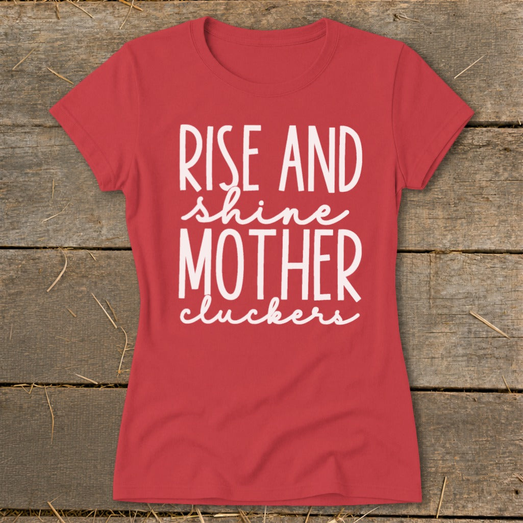Red t-shirt with white text reading "Rise and shine mother cluckers".