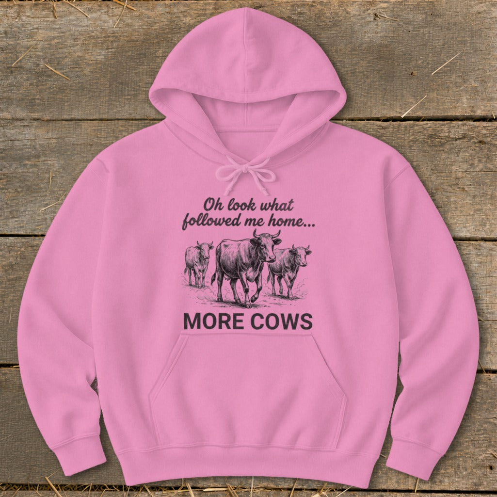 Pink hoodie with "Oh look what followed me home... MORE COWS" and cow graphic.