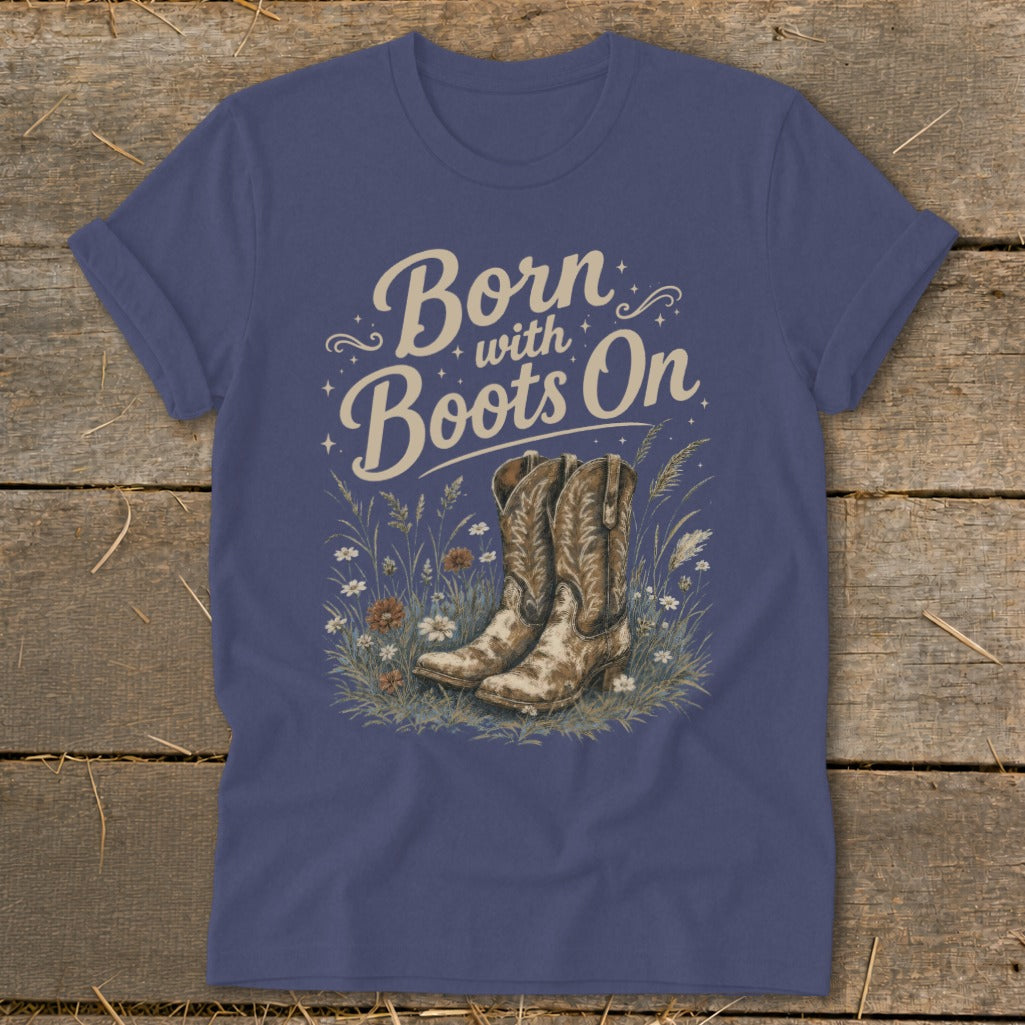 Navy t-shirt graphic with "Born with Boots On" text and cowboy boots in wildflowers.