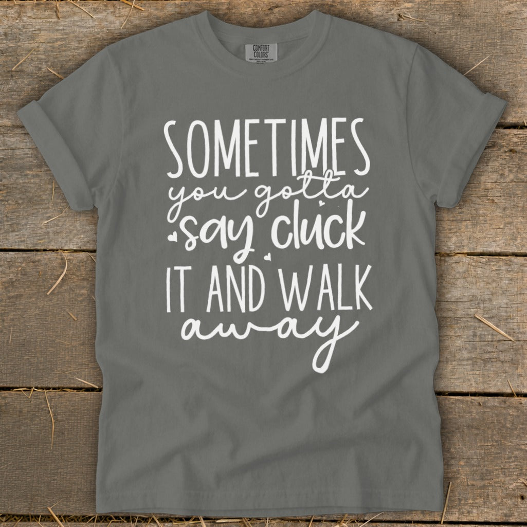 Gray t-shirt with white text "Sometimes you gotta say cluck it and walk away".