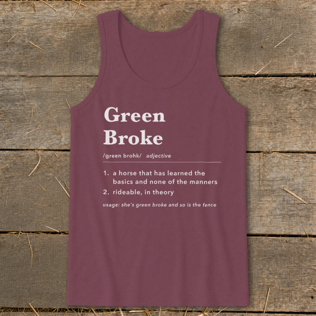 Maroon women's tank top with a dictionary definition print of Green Broke against a wooden background.