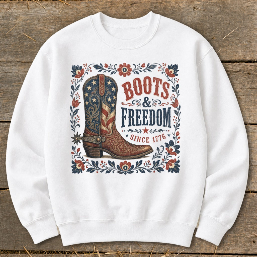 White sweatshirt with "Boots & Freedom Since 1776" text and an American flag cowboy boot design.